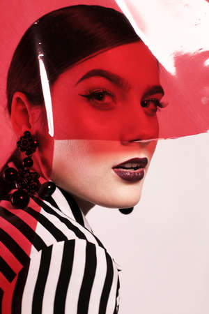 fashion studio photo of gorgeous woman in extravagant photoshoot. bright makeup and fashion clothesの写真素材