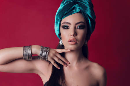 fashion studio photo of gorgeous woman with bright makeup in  oriental style clothesの写真素材
