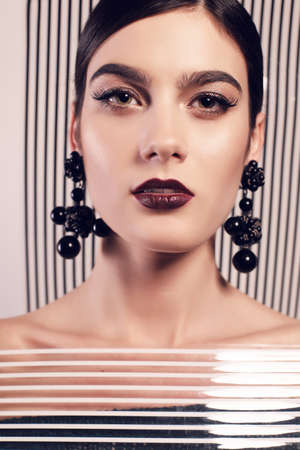 fashion studio photo of gorgeous woman in extravagant photoshoot. bright makeup and fashion clothesの写真素材