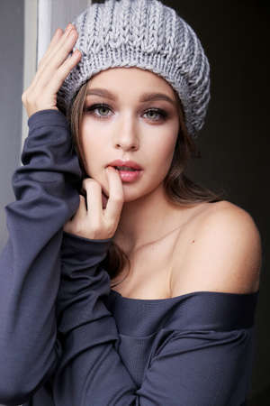 fashion photo of beautiful young woman with natural hair and makeup, in casual clothes ,posing in studioの写真素材