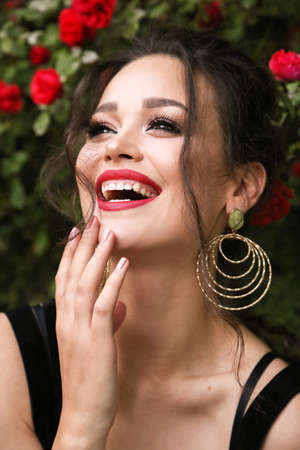 fashion outdoor photo of beautiful sexy girl with dark curly hair and bright makeup in dress in...