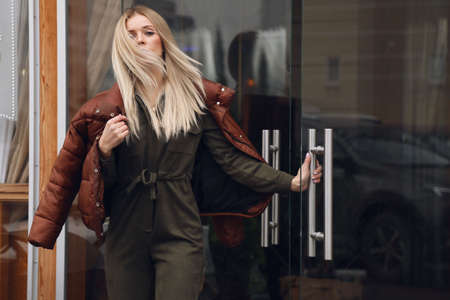 fashion outdoor photo of beautiful sexy woman with blond hair in casual clothes posing on the street...