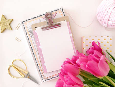 white desk with paper and flowersの写真素材