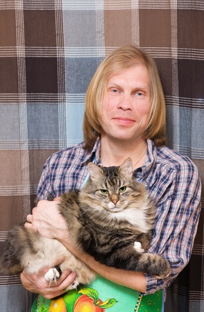 Man and big striped catの写真素材