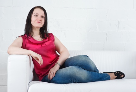 Young woman resting on sofa at homeの写真素材