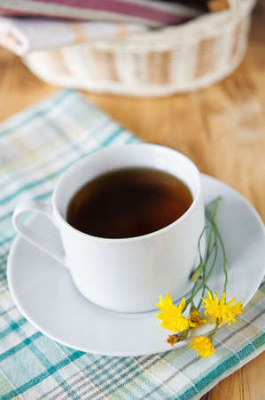 Cup of tea and yellow flowersの写真素材