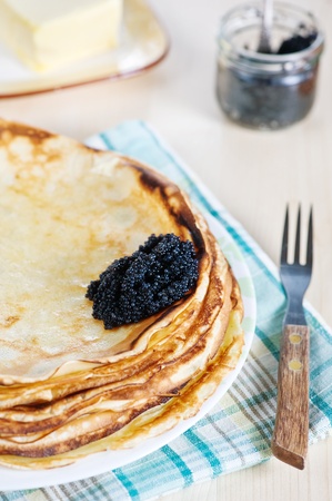 Stack of pancakes with black caviarの写真素材