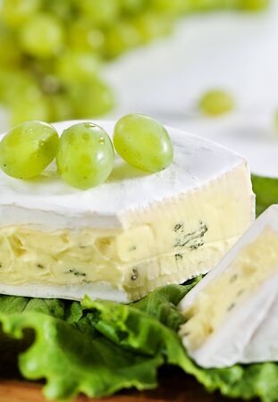 Cheese with blue mould and grapeの写真素材