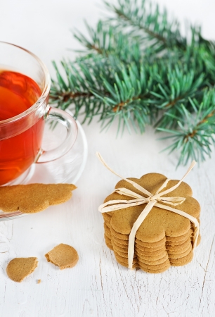 Christmas cookies, cup of tea and fir branchの写真素材