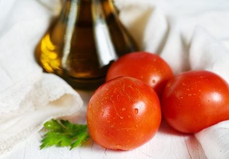 Red tomatoes and olive oil in the glass jarの写真素材