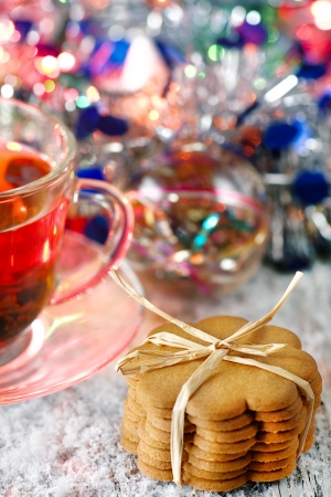 Christmas cookies, cup of tea and shiny garlandの写真素材