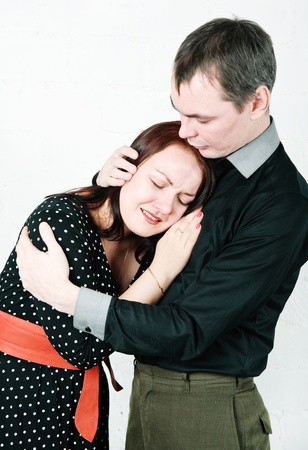 Man hugging and comforting his crying womanの写真素材
