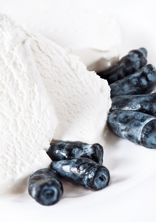 Ice cream with woodbine berries on white backgroundの写真素材