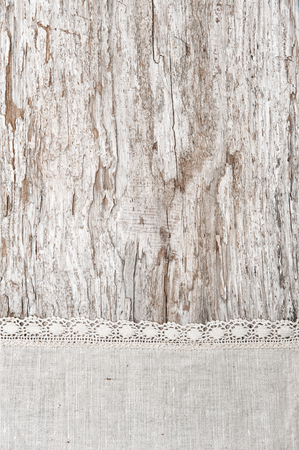 Linen fabric with lace on the old rustic wooden backgroundの写真素材