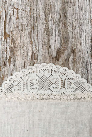 Linen fabric with lace on the old rustic wooden backgroundの写真素材