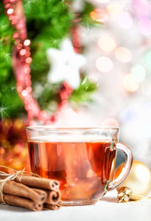Christmas cup of tea and cinnamon on bokeh backgroundの写真素材
