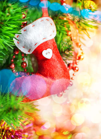 Christmas background with red sock on fir treeの写真素材