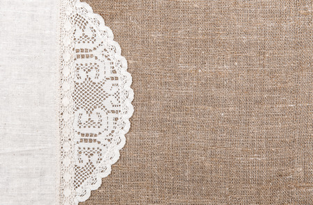 Burlap background with white lacy and linen clothの写真素材