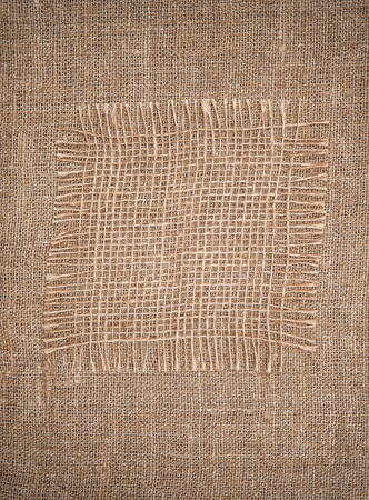 Sacking piece on rude burlap backgroundの写真素材