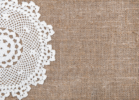 Burlap background and white lacy clothの写真素材