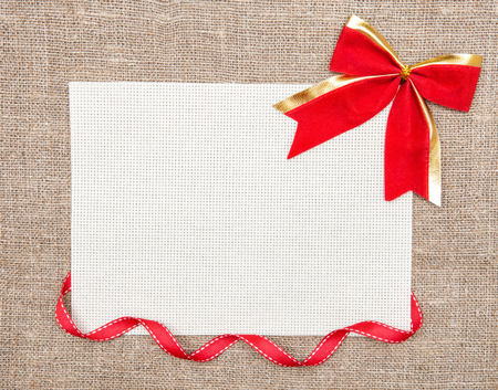 Valentine card with red ribbon and bow on burlap の写真素材