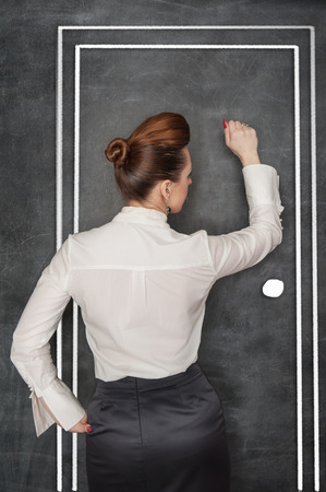 Stylish business woman in the white blouse knock on drawing doorの写真素材