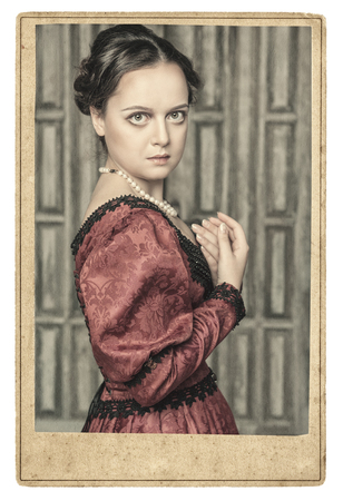 Portrait of young beautiful medieval woman in old photo frameの写真素材
