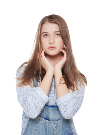 Young fashion girl in jeans overalls posing isolated on white backgroundの写真素材