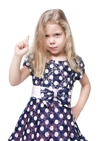 Strict beautiful little girl with blond hair isolated over white backgroundの写真素材