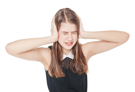Young teenager girl covering ears with her hands isolated on white backgroundの写真素材