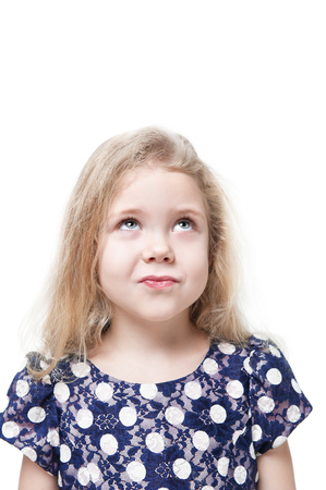 Beautiful little girl skeptically looking on something isolated over white backgroundの写真素材