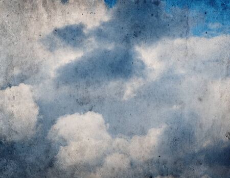Vintage grunge background of blue sky with cloudsの写真素材