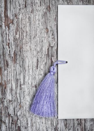 Wooden grunge background with paper and tassel fringeの写真素材