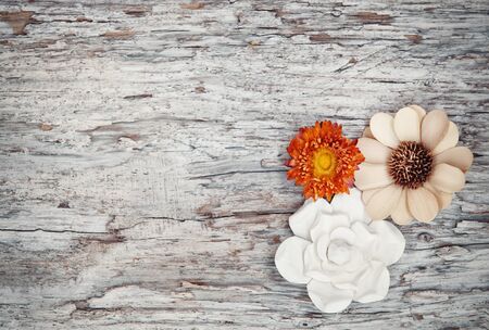 Grunge background with dry flowers on the old weathered woodの写真素材