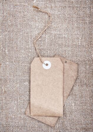 Blank tags retro style on sackcloth textureの写真素材