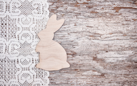 Easter background with wooden rabbit on the old rough woodの写真素材