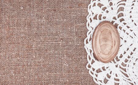 Vintage background with lace on the old rude burlapの写真素材
