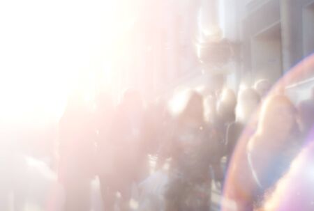 Blurred light abstract background with people on the street