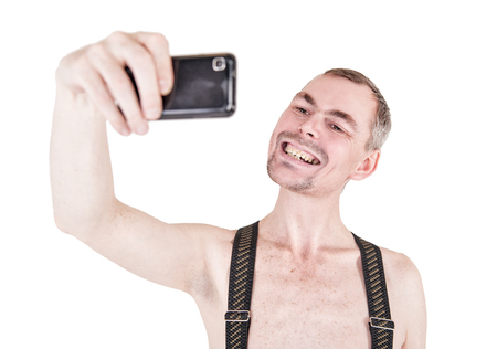 Funny naked man taking selfie isolated on whiteの写真素材