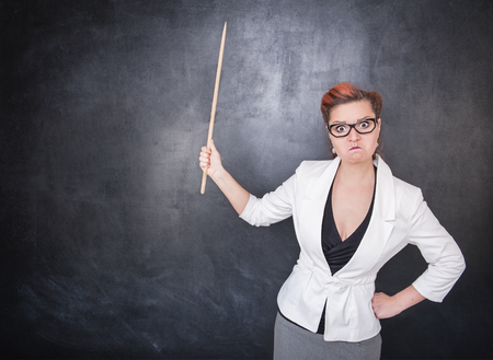 Angry teacher with pointer on the chalkboard blackboard background
