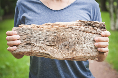 Man holding empty wooden board outdoor. Template mock upの写真素材