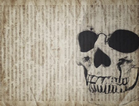 Halloween background with human skull on old vintage newspaperの写真素材