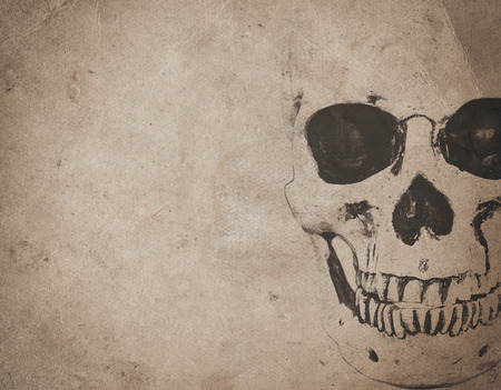 Halloween background with human skull on old vintage newspaperの写真素材