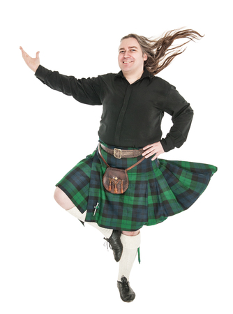 Scottish man in traditional national costume with blowing kilt isolatedの写真素材
