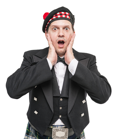 Surprised man in traditional Scottish costume isolatedの写真素材