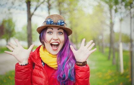 Young beautiful fashion hipster woman with colorful hair outdoorの写真素材