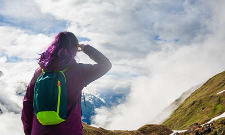 Woman hiker standing on the top of mountain outdoor. Back poseの写真素材