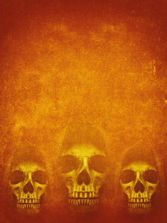 Human skull in hood on dark orange background. Halloween grunge bannerの写真素材