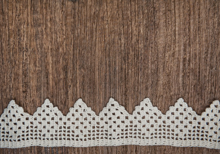 Vintage background with lace fabric on the old woodの写真素材
