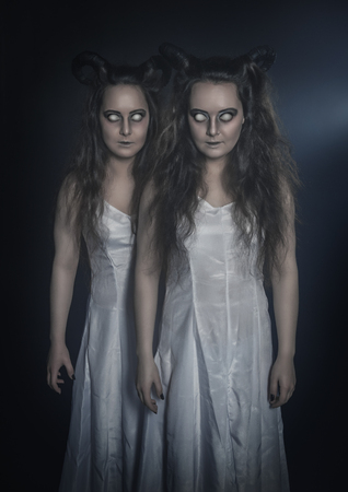 Two terrible ghost with horns on dark backgroundの写真素材